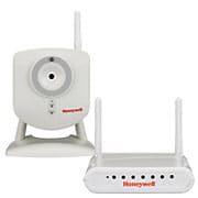 A white Honeywell security camera and a matching wireless receiver with antennas, both featuring the Honeywell logo, ensure robust wireless communication and seamless Alarm Monitoring.