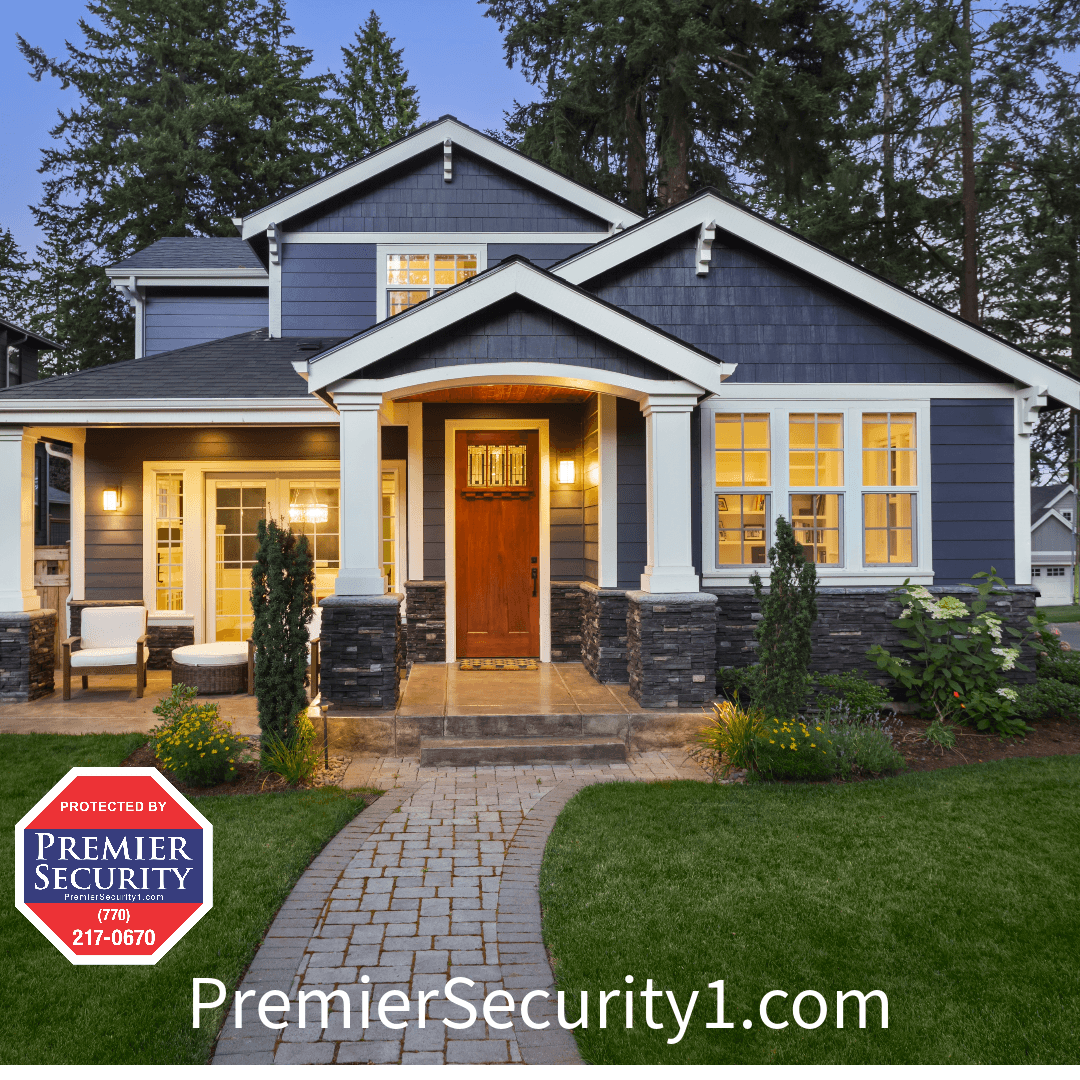 A modern two-story house with blue exterior and white trim, front porch, and well-maintained lawn features a security sign in the yard that reads "Premier Security" with contact information. For tips on home safety, visit our website: PremierSecurity1.com.