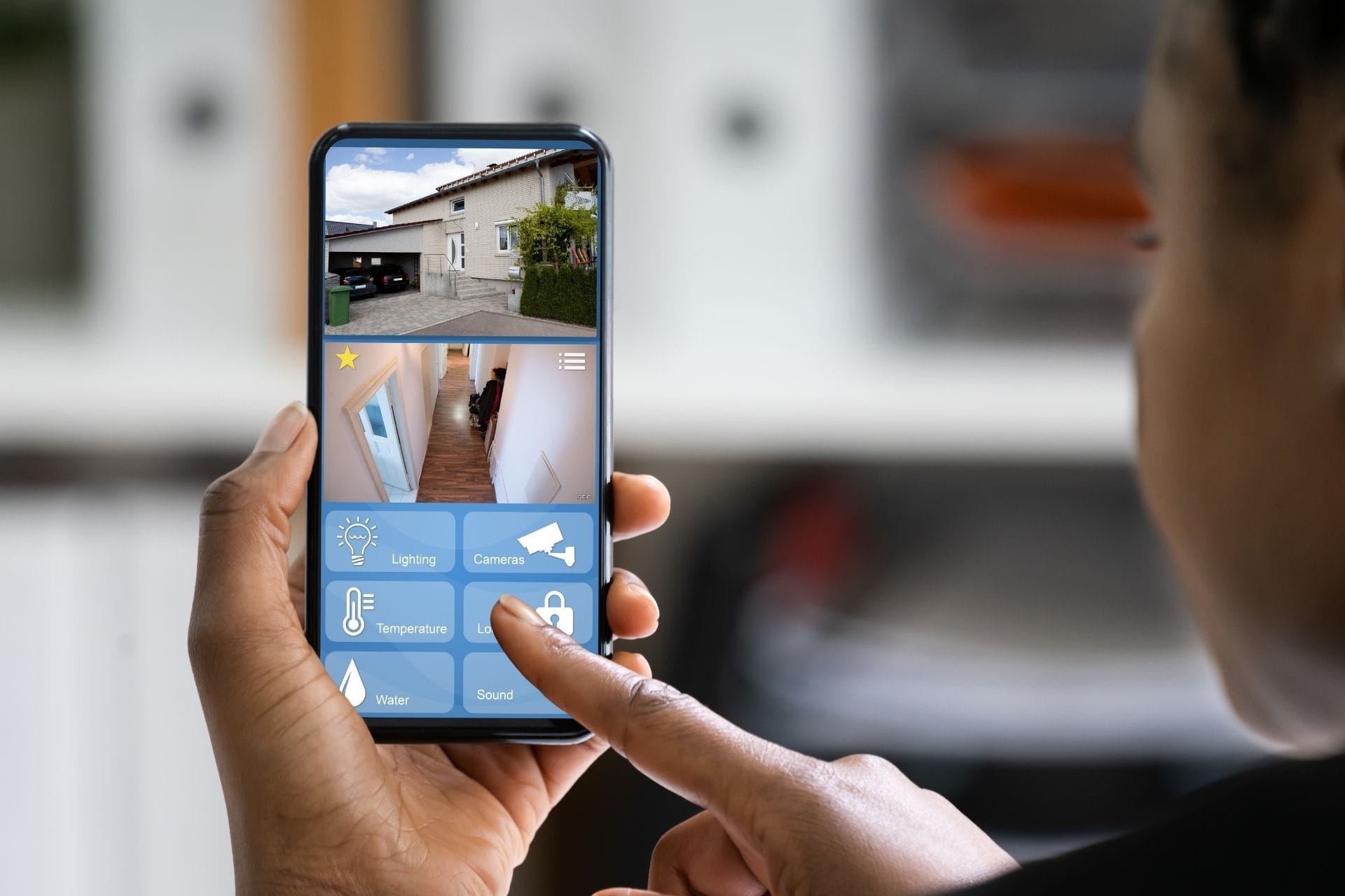 A person using a smartphone app to control home security features, including camera, temperature, lighting, sound, and water settings for enhanced home protection.