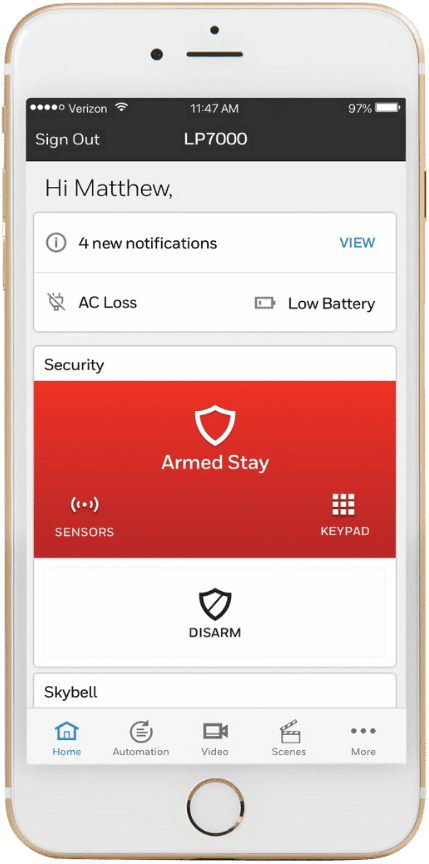 A smartphone screen showcases a wireless home security app, featuring alerts for AC loss and low battery. The system remains in "Armed Stay" mode, offering options to disarm, view sensors, or access the keypad for seamless monitoring.