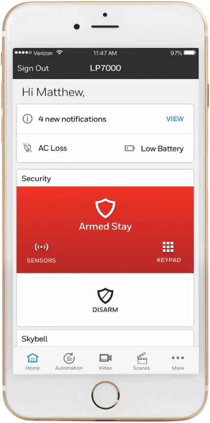 A smartphone screen showcases a wireless home security app, featuring alerts for AC loss and low battery. The system remains in "Armed Stay" mode, offering options to disarm, view sensors, or access the keypad for seamless monitoring.