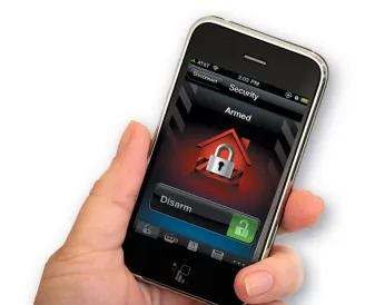 A hand holds a smartphone featuring the Alarm.com security app, displaying a red lock icon with "Armed" status and a prominent green "Disarm" button.